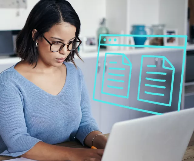 Woman managing documents on laptop